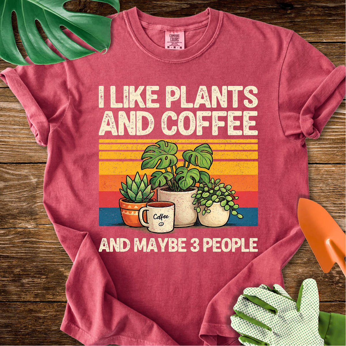 Crimson red Comfort Colors T-shirt with plants, coffee, and retro stripes with "I Like Plants and Coffee and Maybe 3 People".