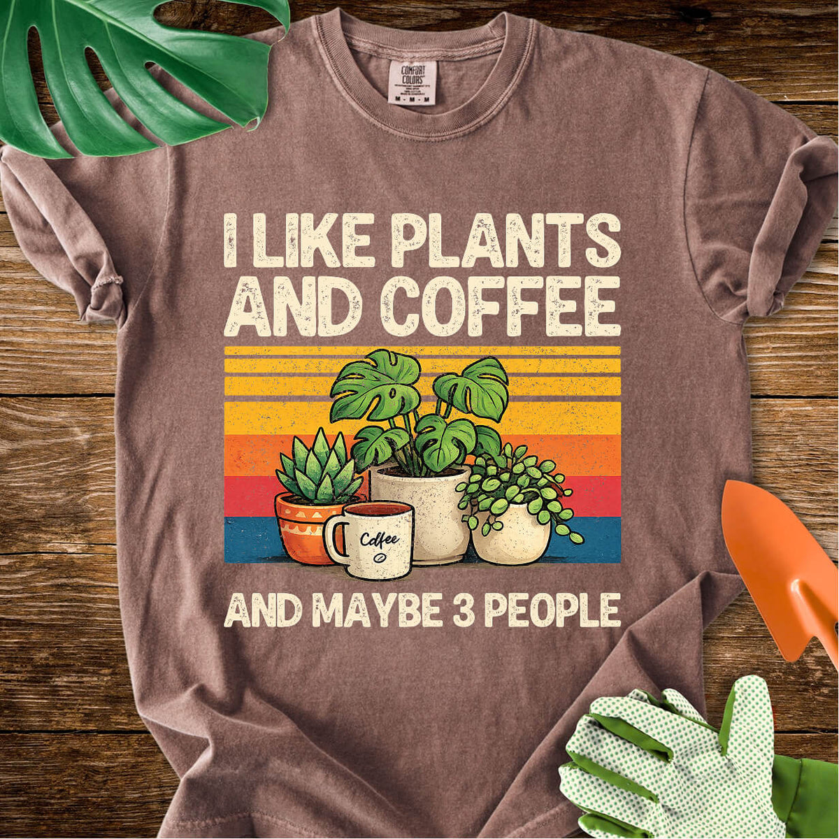 Espresso brown Comfort Colors T-shirt with plants, coffee, and retro stripes with "I Like Plants and Coffee and Maybe 3 People".