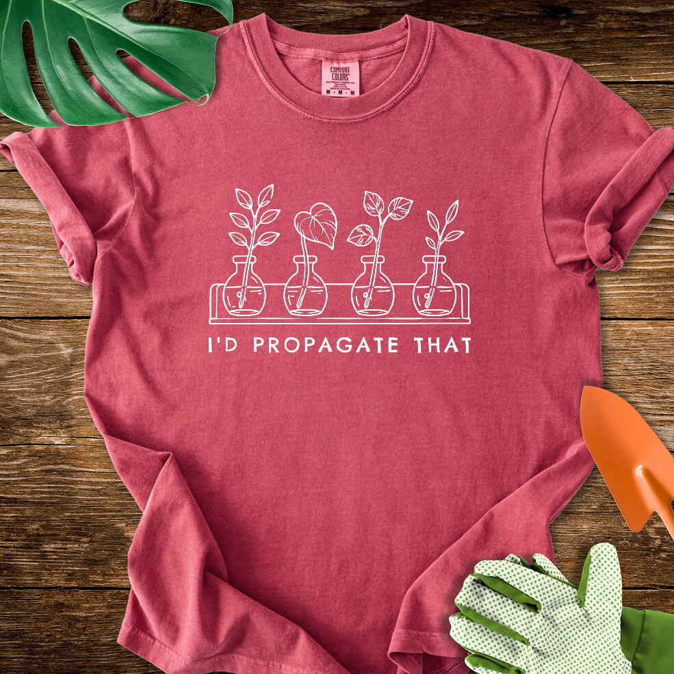 Crimson red Comfort Colors T-shirt with cuttings in propagation bottles beneath "I'd Propagate That".