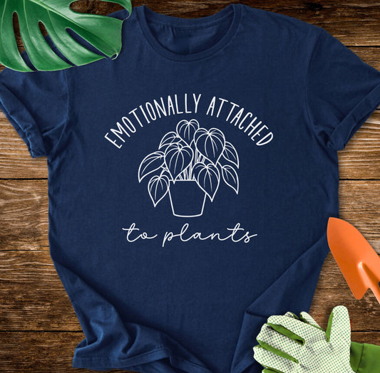 Navy blue T-shirt with a leafy houseplant and "Emotionally Attached to Plants".