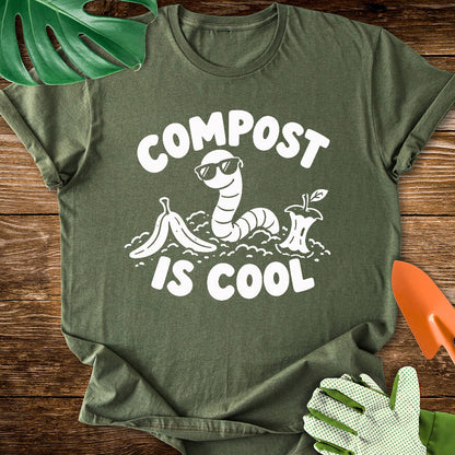Military green T-shirt with a worm in sunglasses among scraps with "Compost Is Cool".