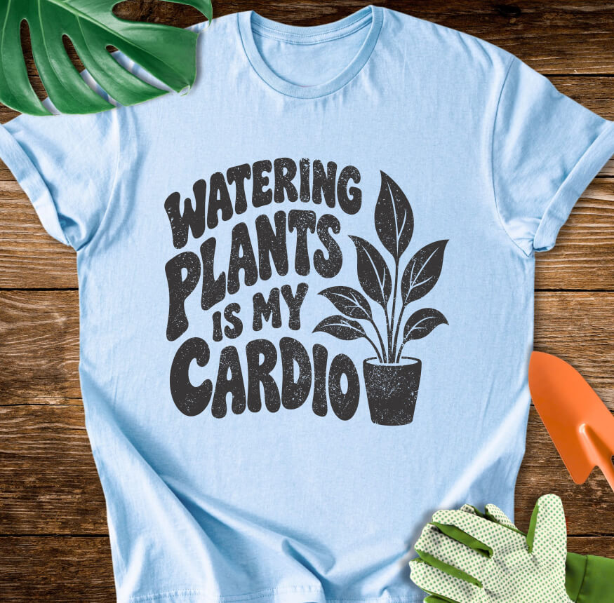 Light blue T-shirt with a potted plant beside bold "Watering Plants Is My Cardio" lettering.