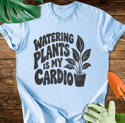 Light blue T-shirt with a potted plant beside bold "Watering Plants Is My Cardio" lettering.