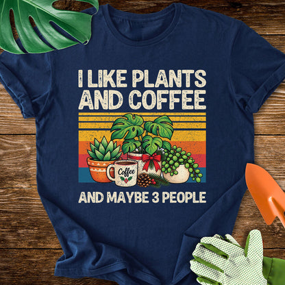 Navy blue T-shirt with Christmas plants and coffee with "I Like Plants and Coffee and Maybe 3 People".