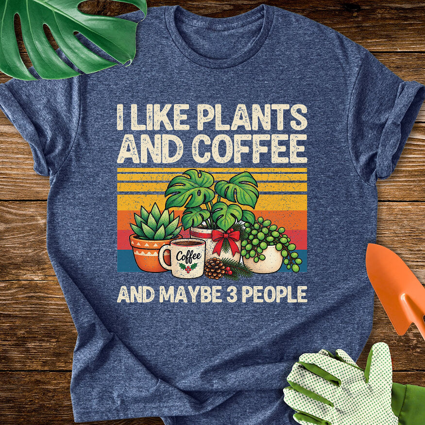 Heather navy blue T-shirt with Christmas plants and coffee with "I Like Plants and Coffee and Maybe 3 People".