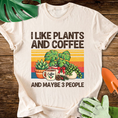 Natural cream T-shirt with Christmas plants and coffee with "I Like Plants and Coffee and Maybe 3 People".