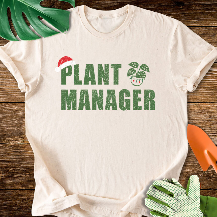 Natural cream T-shirt with a Santa hat, festive plant pot, and "Plant Manager" lettering.