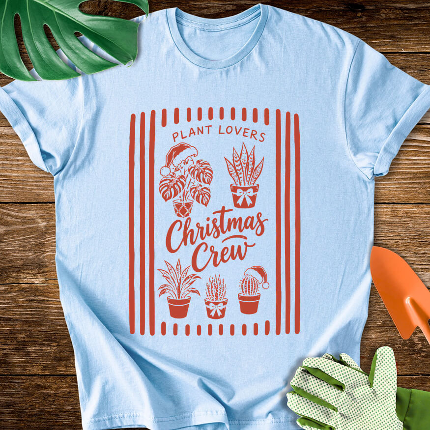 Light blue T-shirt with festive houseplants in a striped "Plant Lovers Christmas Crew" design.