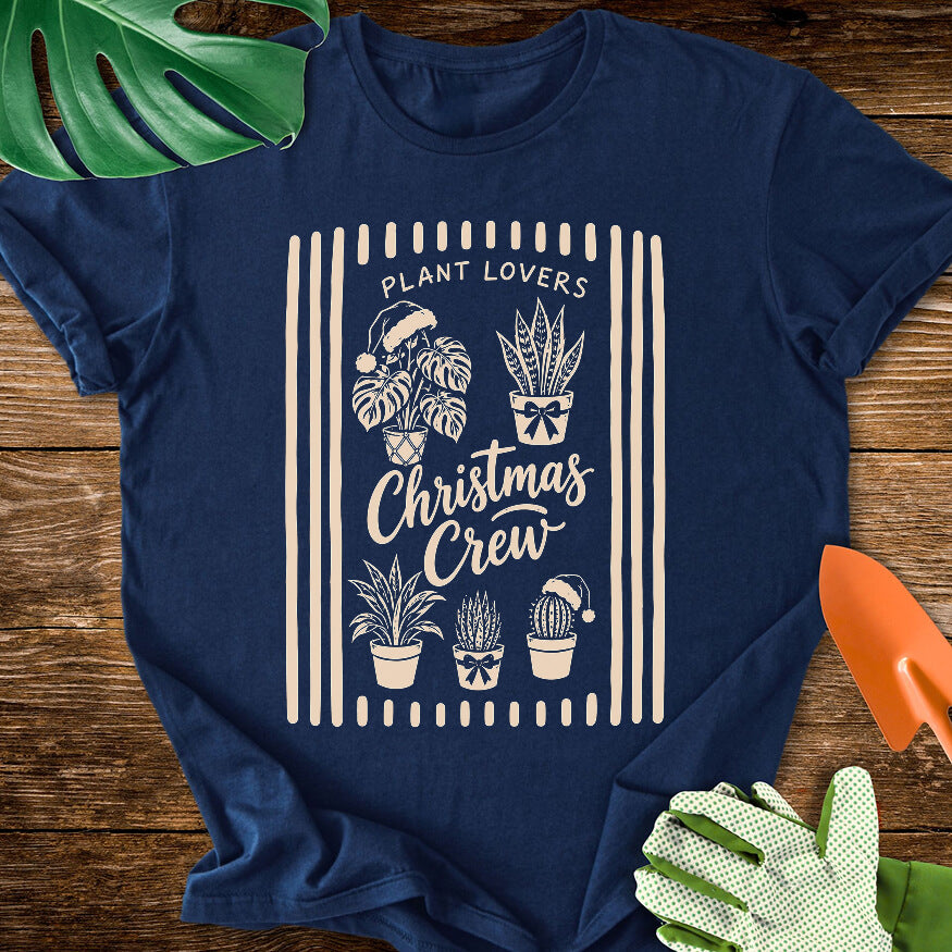 Navy blue T-shirt with festive houseplants in a striped "Plant Lovers Christmas Crew" design.