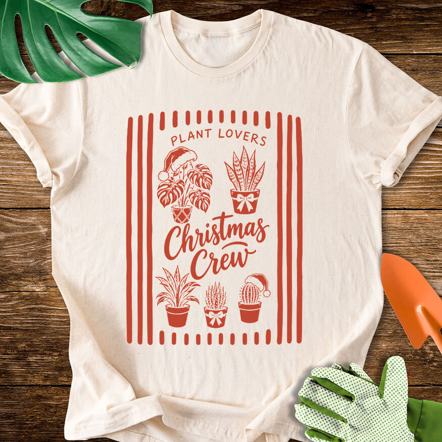 Natural cream T-shirt with festive houseplants in a striped "Plant Lovers Christmas Crew" design.