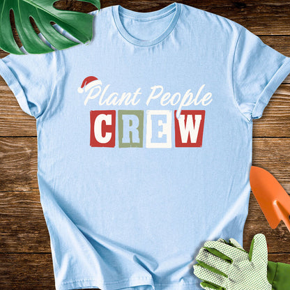 Light blue T-shirt with a Santa hat above festive "Plant People Crew" lettering.