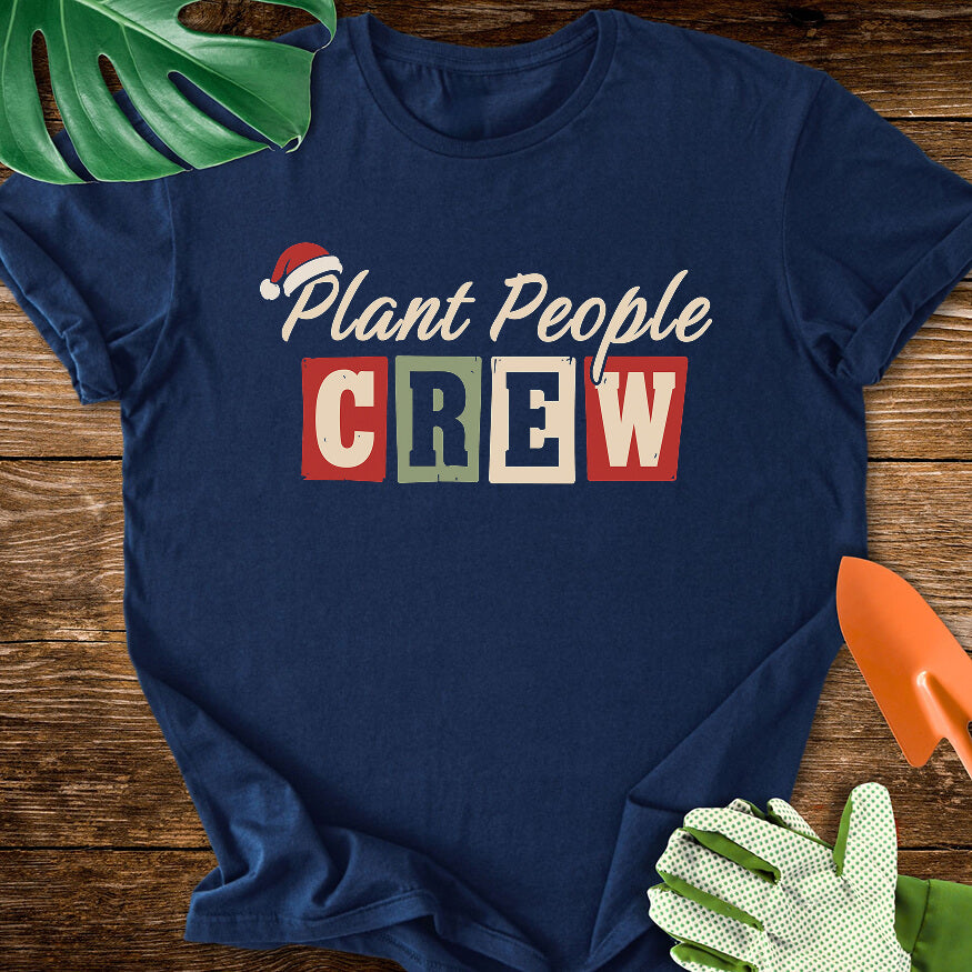 Navy blue T-shirt with a Santa hat above festive "Plant People Crew" lettering.
