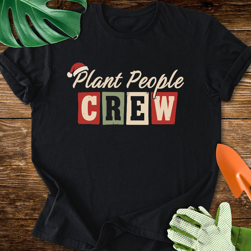 Black T-shirt with a Santa hat above festive "Plant People Crew" lettering.
