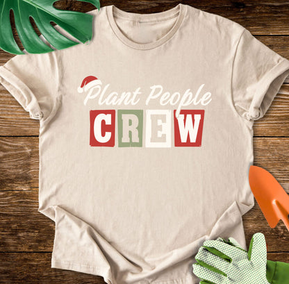 Sand T-shirt with a Santa hat above festive "Plant People Crew" lettering.