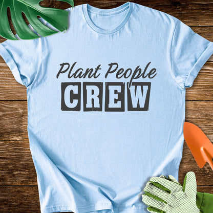 Light blue T-shirt with vintage-style lettering reading "Plant People Crew".