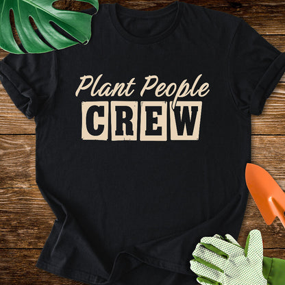 Black T-shirt with vintage-style lettering reading "Plant People Crew".