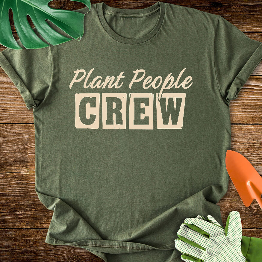 Military green T-shirt with vintage-style lettering reading "Plant People Crew".