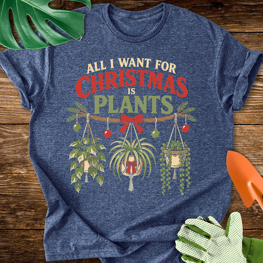 Heather navy blue T-shirt with festive hanging houseplants beneath "All I Want for Christmas Is Plants".