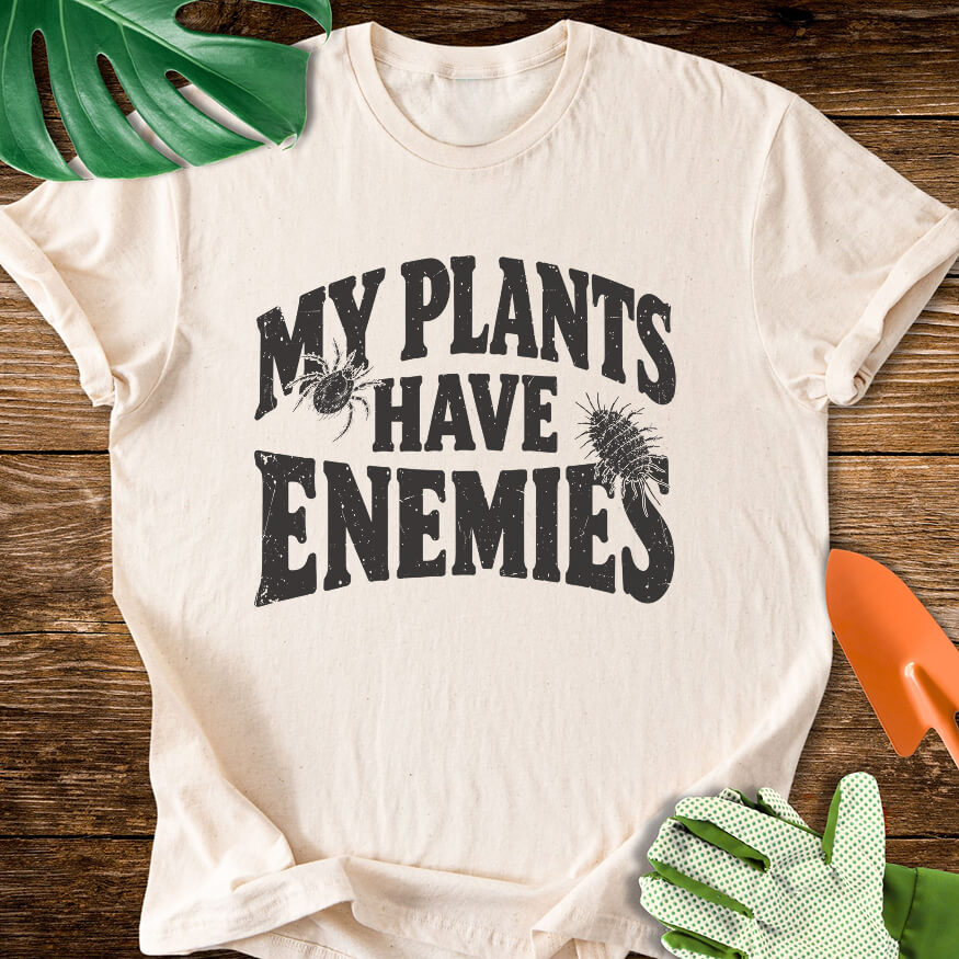 Natural cream T-shirt with plant pest illustrations around "My Plants Have Enemies" lettering.