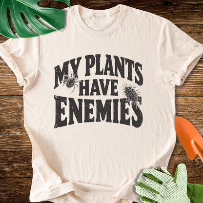 Natural cream T-shirt with plant pest illustrations around "My Plants Have Enemies" lettering.