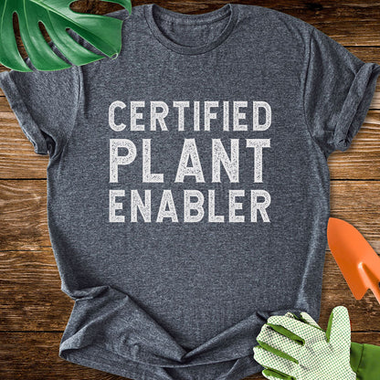 Dark heather gray T-shirt with bold distressed lettering reading "Certified Plant Enabler".