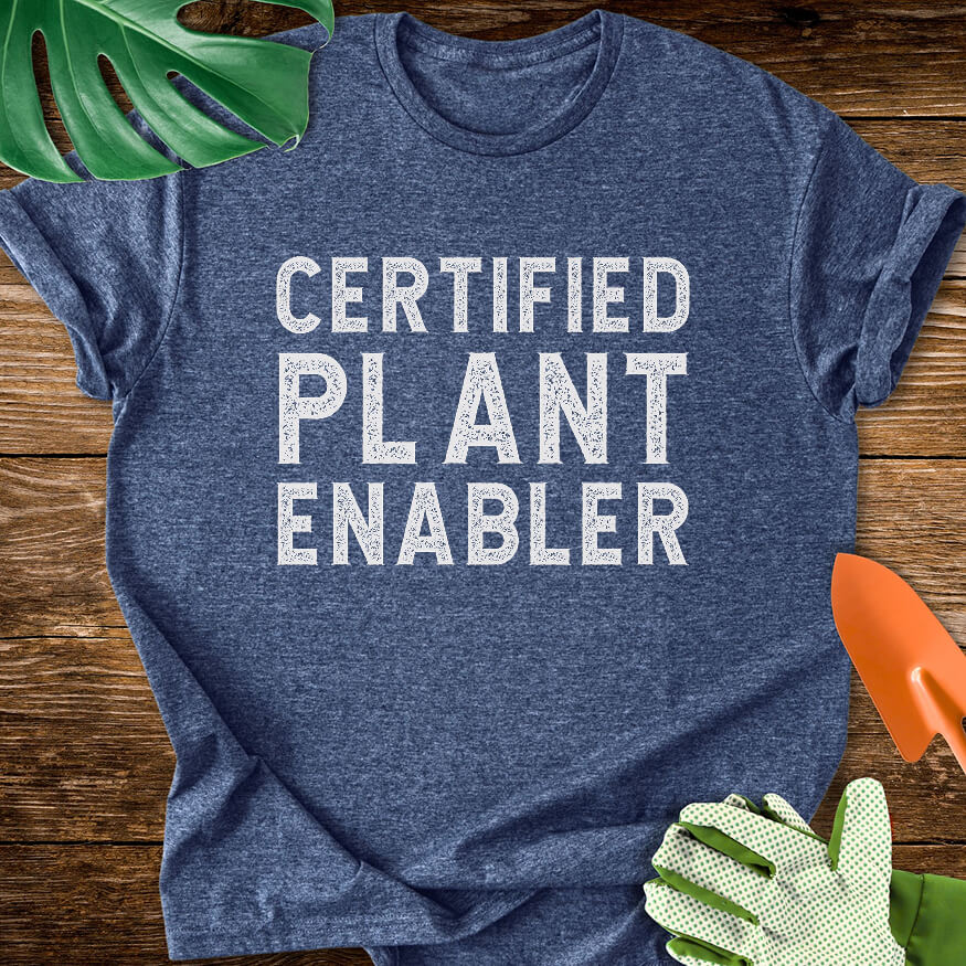 Heather navy blue T-shirt with bold distressed lettering reading "Certified Plant Enabler".