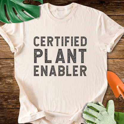 Natural cream T-shirt with bold distressed lettering reading "Certified Plant Enabler".