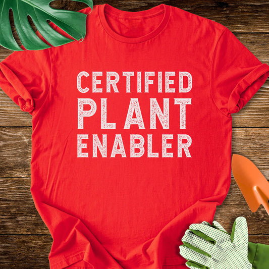 Red T-shirt with bold distressed lettering reading "Certified Plant Enabler".